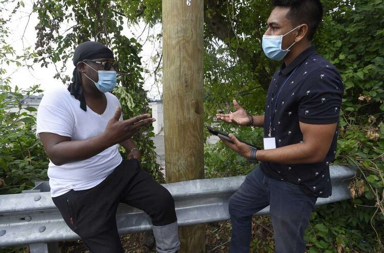  Josiah Mitchell, a client at Pacific House, chats with his case manager Mohammed Mamun on July 23, 2020 in Stamford. Mitchell, an out-of-work day laborer, will get permanent housing in Stamford in September. Photo: Matthew Brown / Hearst Connecticut Media 