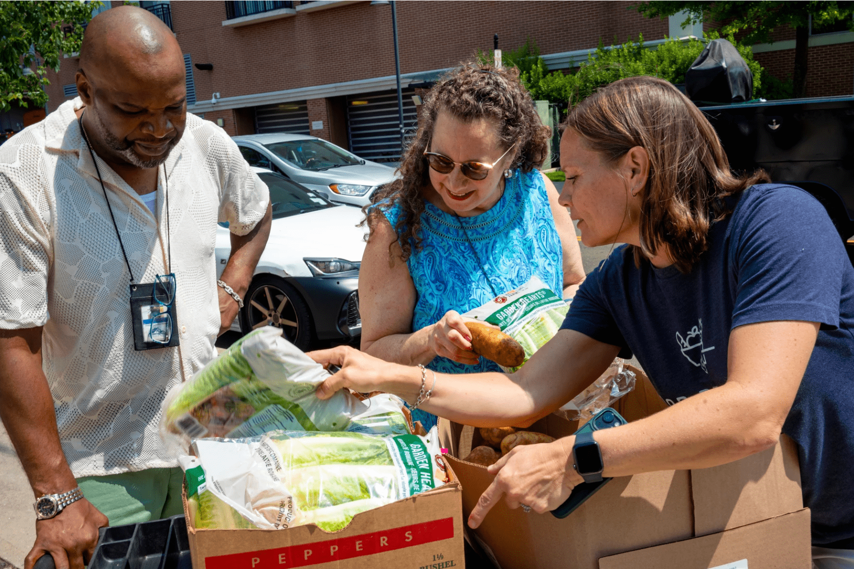 A delivery is received at Pacific House by George Keels, Program Manager (left), Michele Fanwick, Development Director (center), and Karen Saggese, Co-Site Director for Food Rescue US-Fairfield County (right).