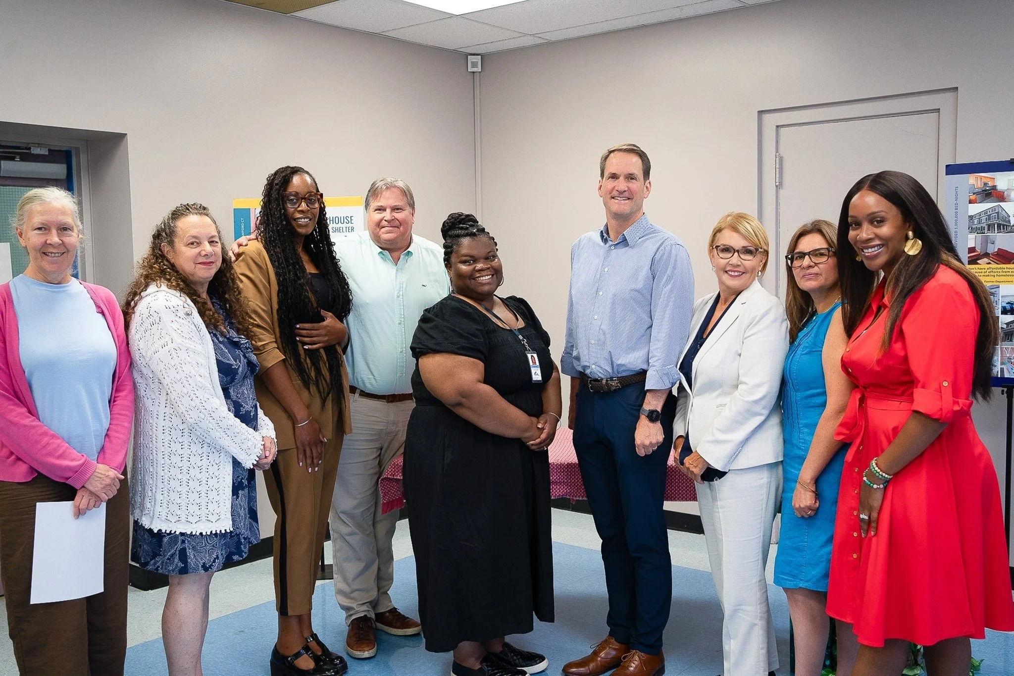 From left to right: Lisa Planchard (Development Associate), Michelle Fanwick (Development Director), Tiara Lofton (Director of Permanent Supportive Housing), Robert Lockhart (Director of Shelter Services), Elizabeth King (Ancillary Program Manager), Congressman Jim Himes, Carmen Colón (President & CEO), Silvia Narvaez (Chief Program Officer), Elsi Lyons (Chief Marketing Officer). 