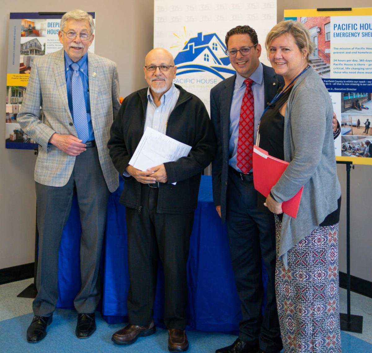 Allan Lang of the Stamford Rotary Trust Fund, Rafael Pagan Jr., Executive Director of Pacific House, Chris Farrugio of the Stamford Rotary Trust Fund, and Jennifer Broadbin of Pacific House.